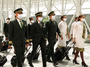 Cabin Crew and Pilots walking through an airport 