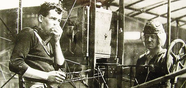 Lieutenant Paul Beck made an early airborne radio transmission, aviators test a receiving set - with the airplane's engine running (US Navy/Ellyson Scrapbook Collection)