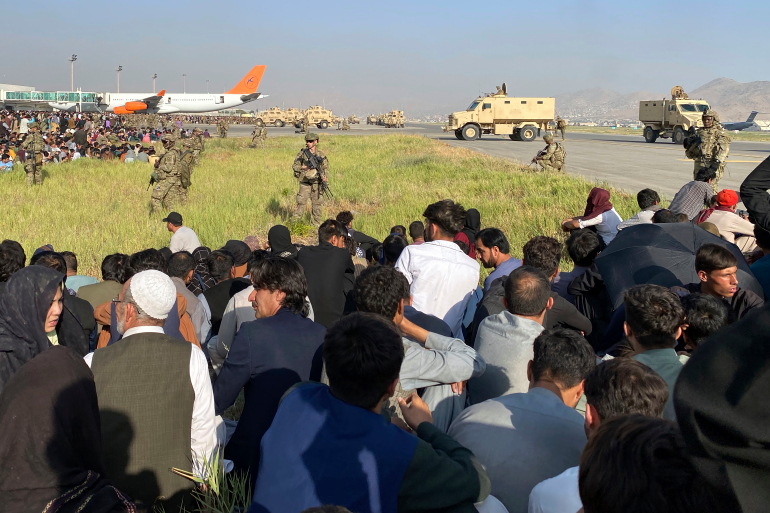 U.S soldiers stand guard along a perimeter at the international airport in Kabul. Several people were killed at the Hamid Karzai International Airport on Monday