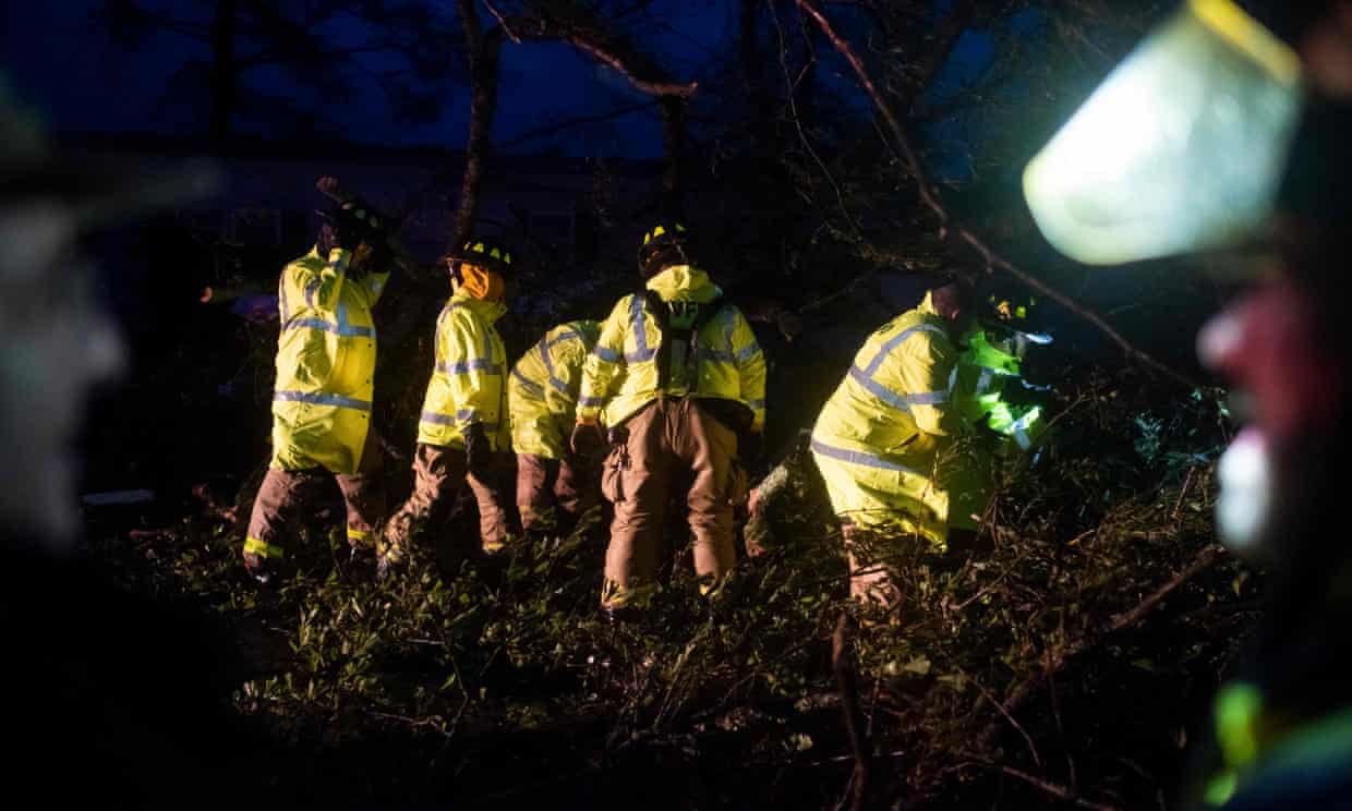 Montegut and Bourg firefighters cut through trees on the road in Bourg, Louisiana as Hurricane Ida passes through