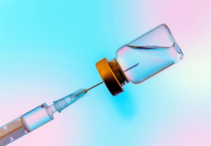 Showing vaccine bottle with needle inside