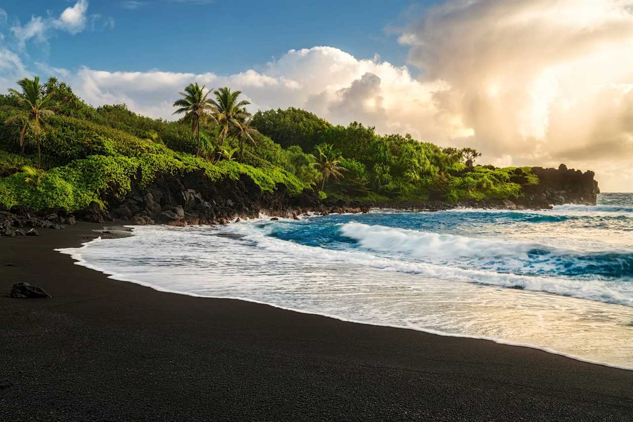 On Maui's Road to Hana you'll find the black sand beach at Waianapanapa State Park. (Photo by Matt Anderson Photography/Getty Images)