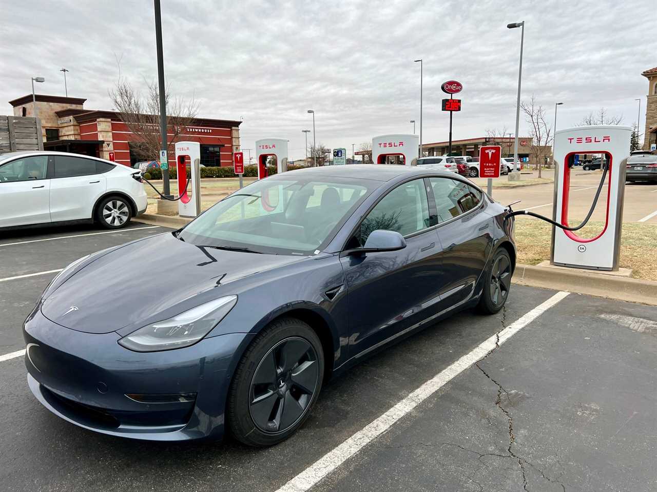 Tesla Model 3 connected to a charger