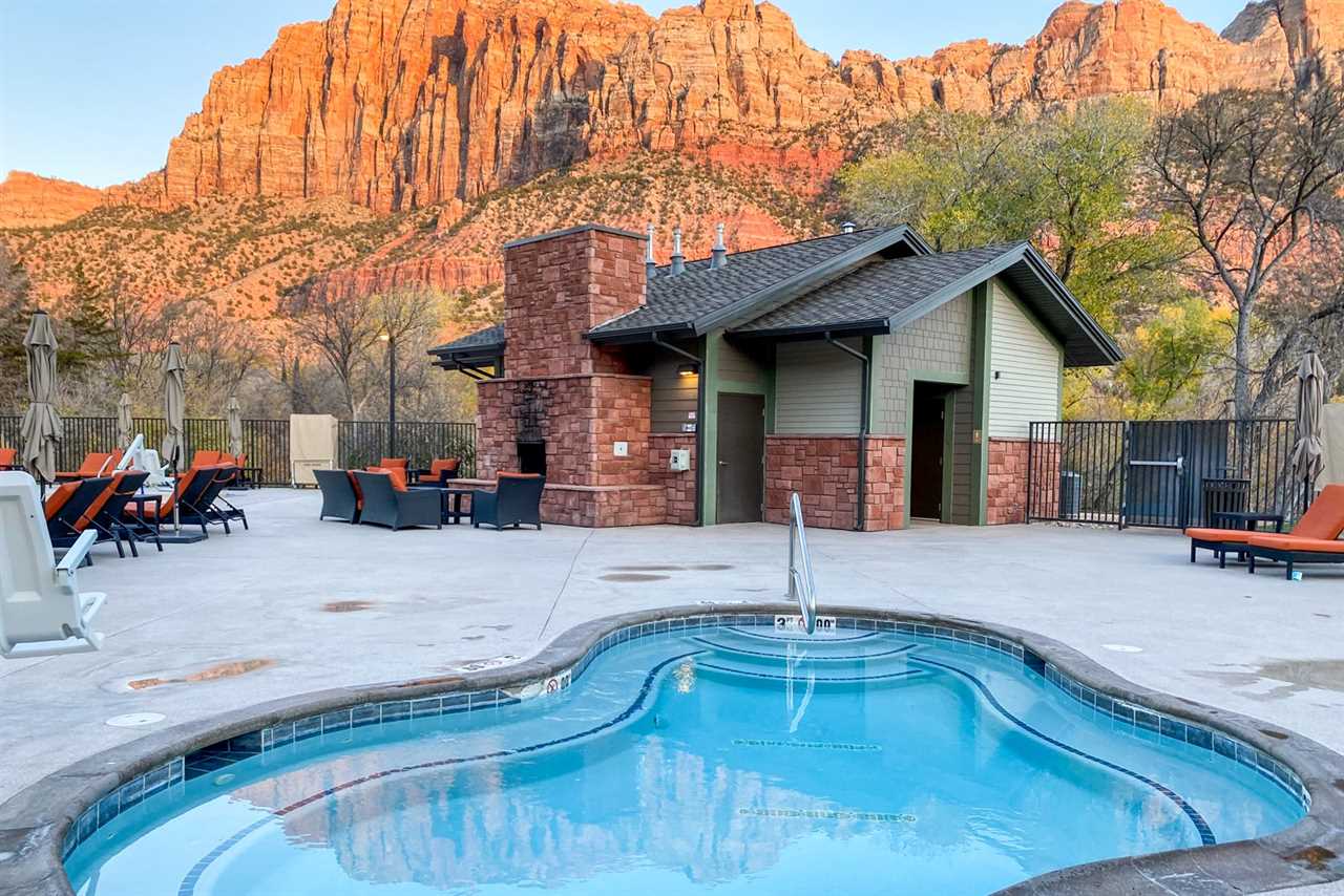 swimming pool below rock formations in Utah