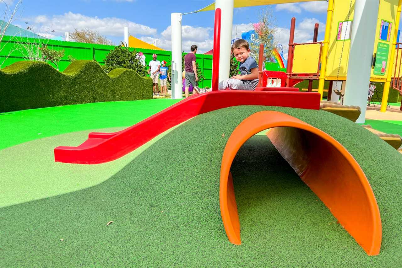 Child playing on slide at Peppa Pig Theme Park