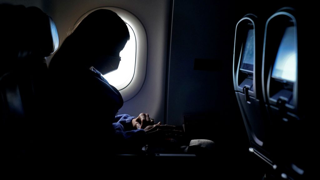 Aircraft passenger wearing a mask