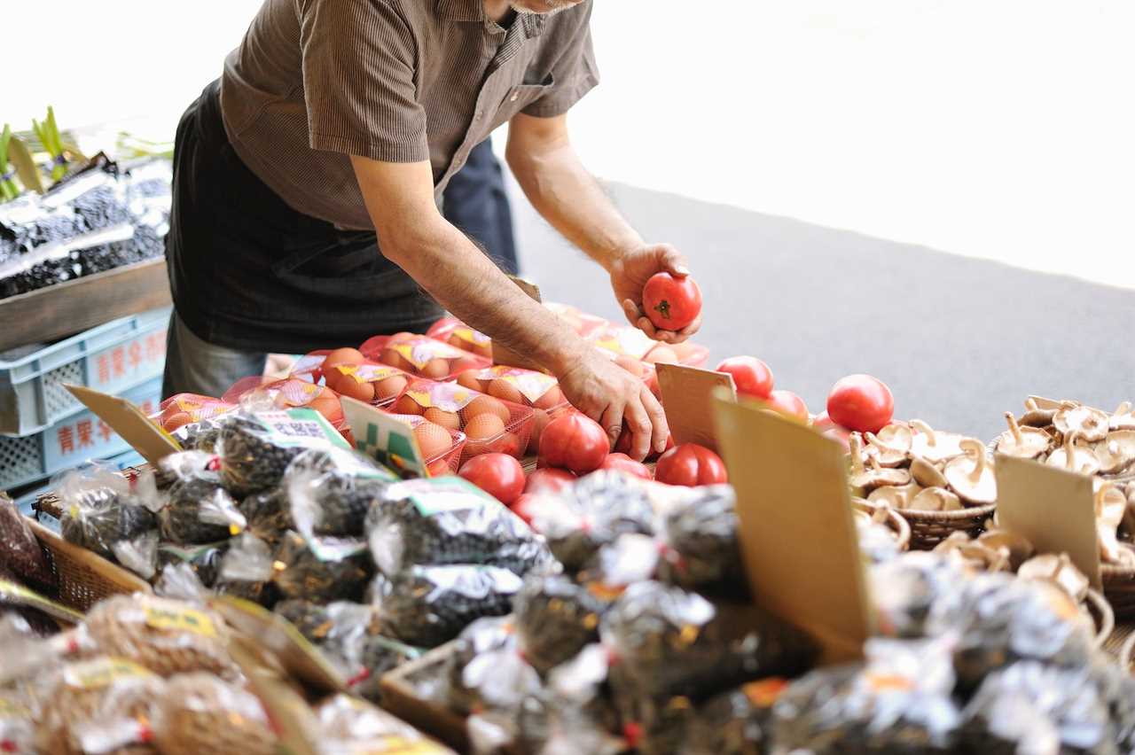 Man selecting tomatoes at the grocery store