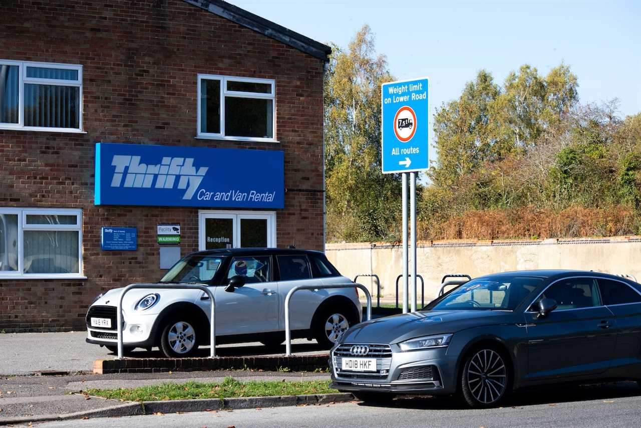 Thrifty car rental storefront with two cars outside