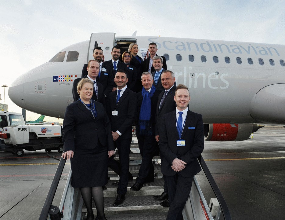 SAS Crew Smiling in front of their airline 