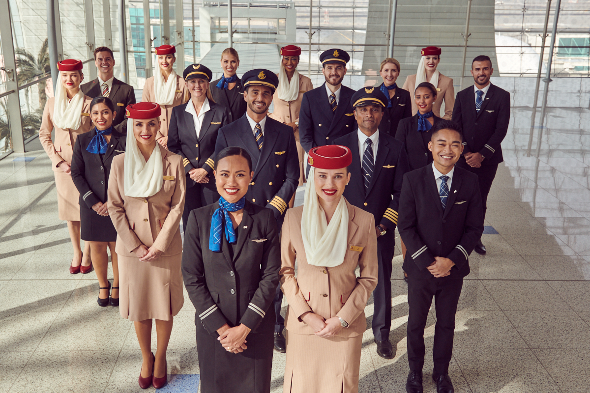 Cabin crew across Emirates and United smile as they launch the aviation partnership