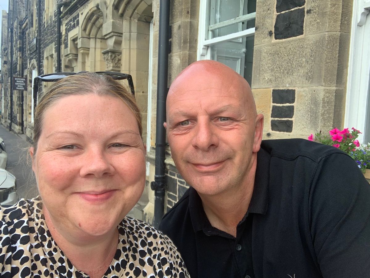 Emma and Barry Etherington smile at the camera whilst taking a selfie