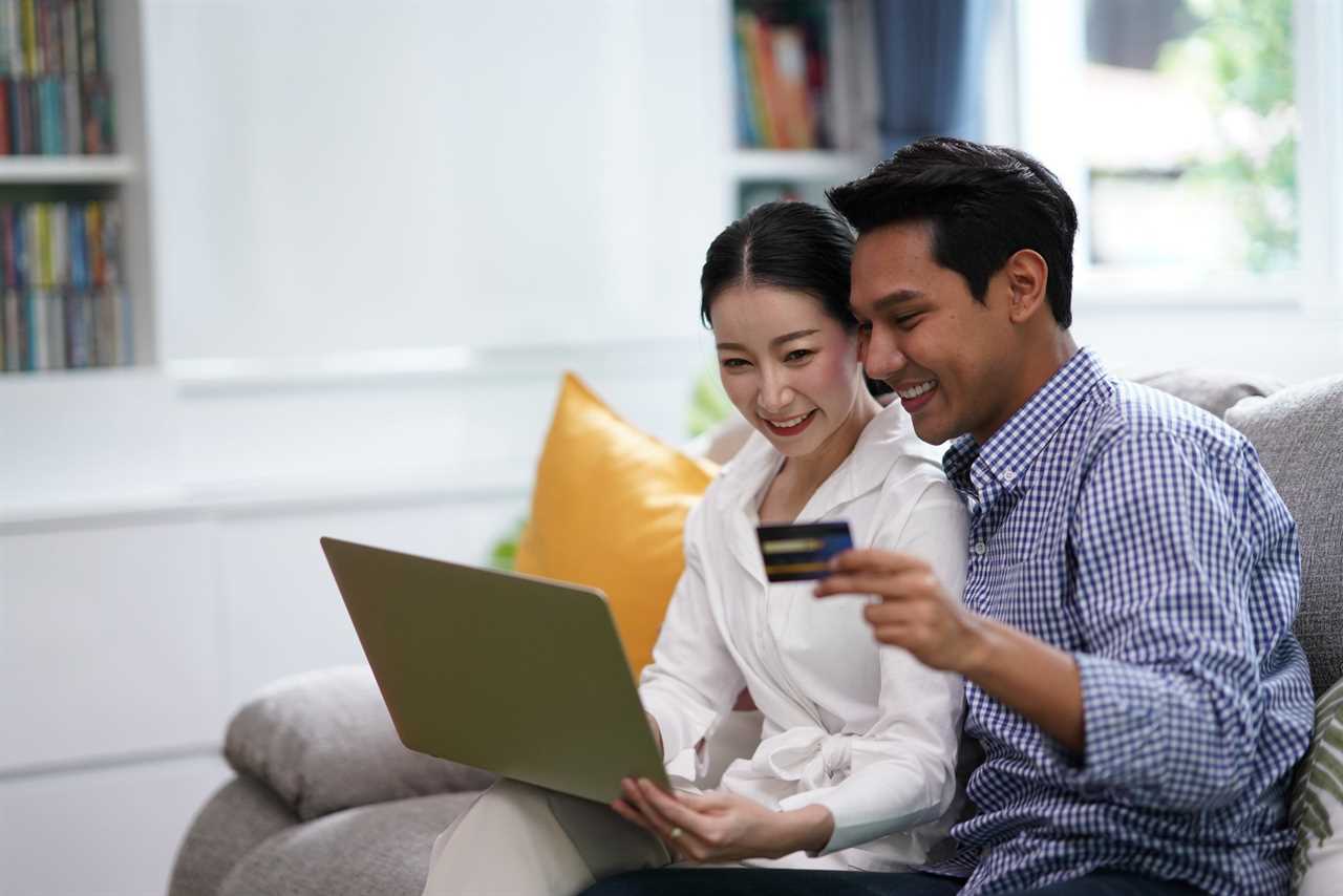 Young couple cheerful using laptop and credit card to shop online