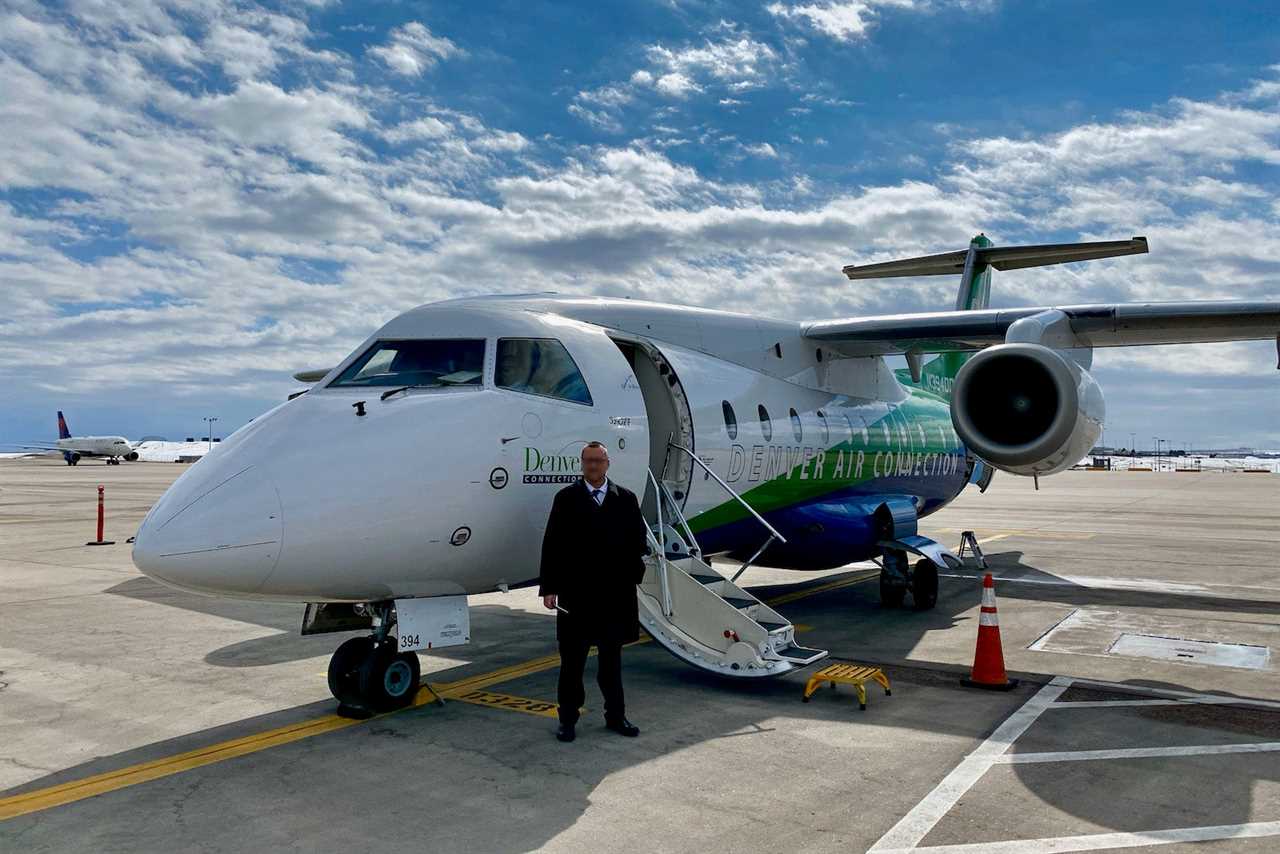 a man stands next to a plane