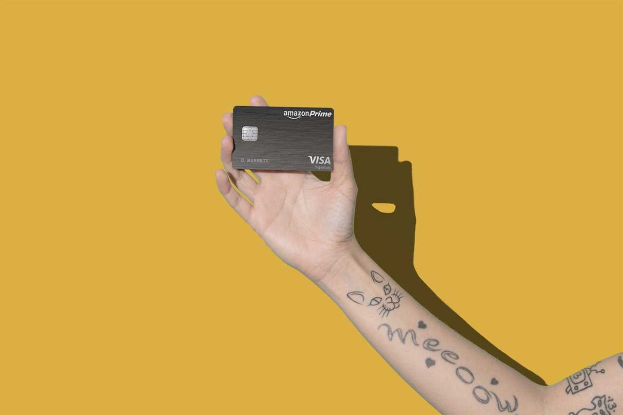 a hand holds a credit card