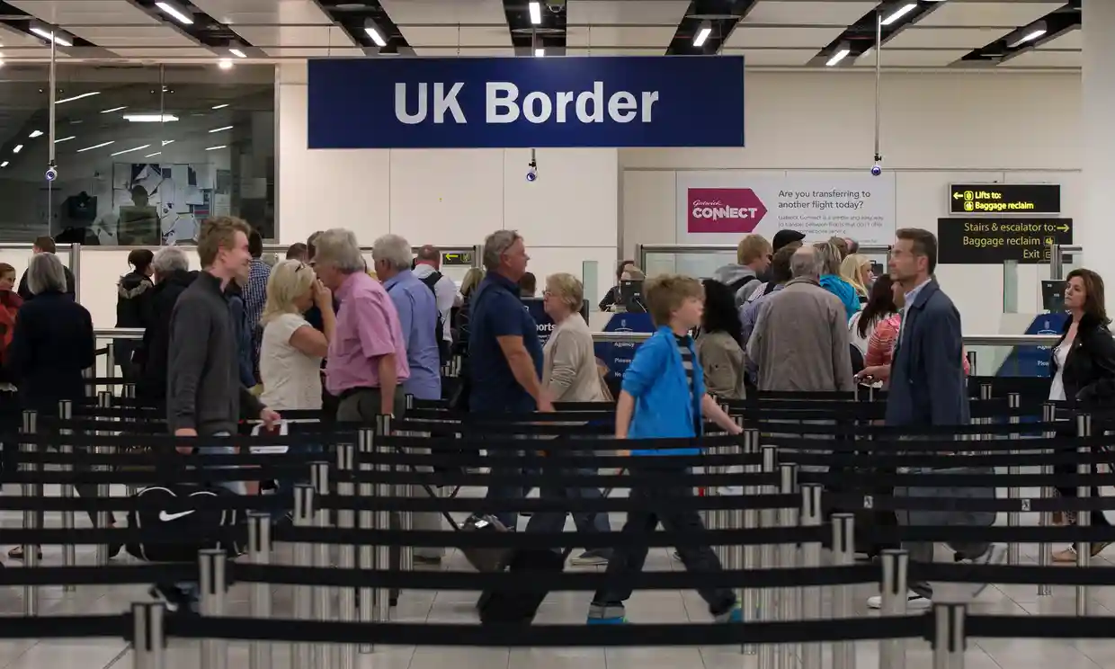 Passengers queue at Border Control - Border Force strikes are set to cause chaos for travellers over the Christmas period