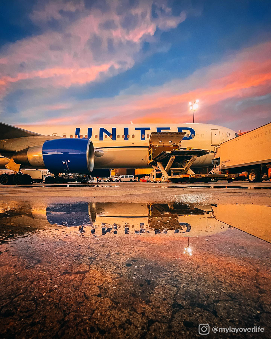 United airlines plane on tarmac against sunset.