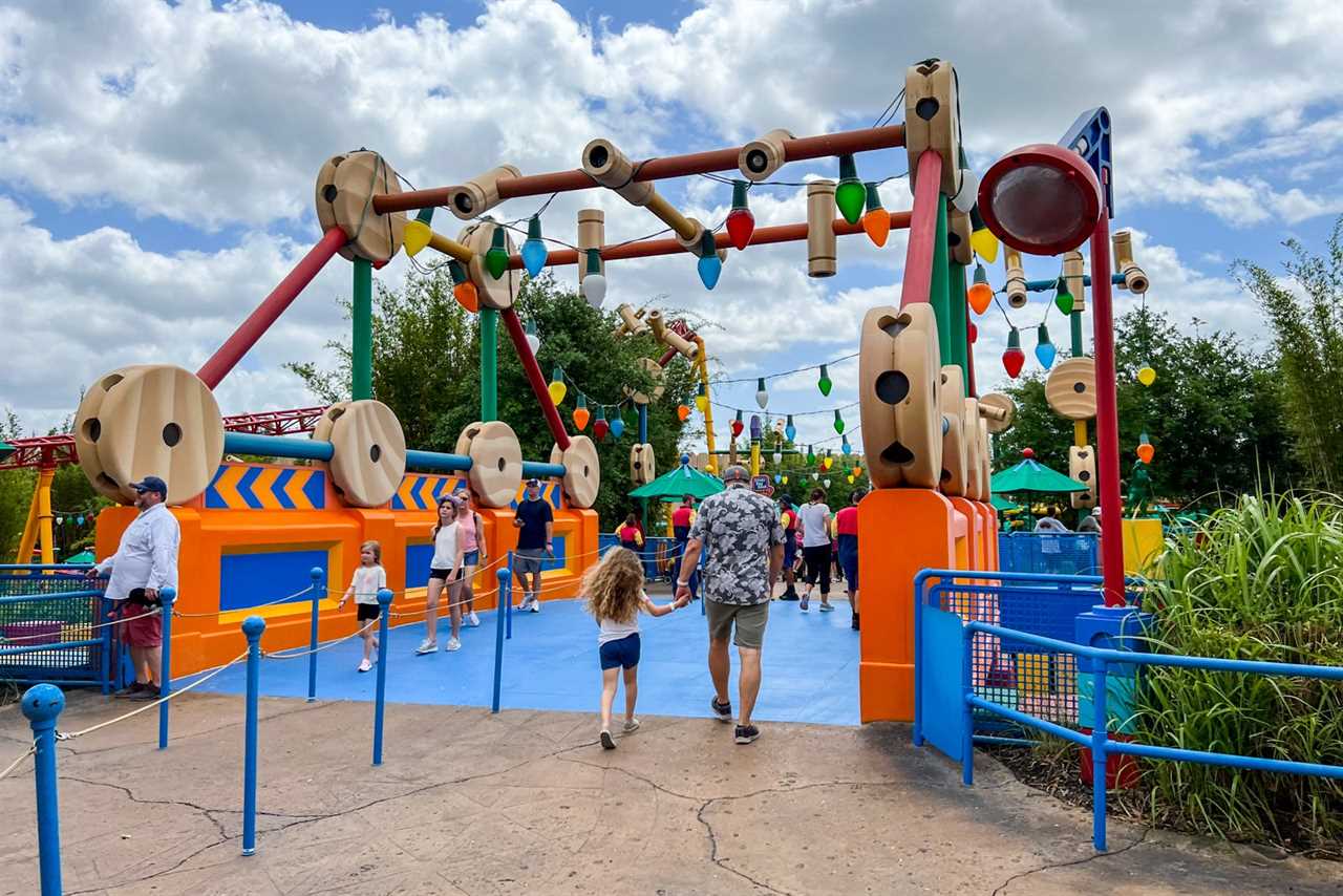 child and parent walking through disney