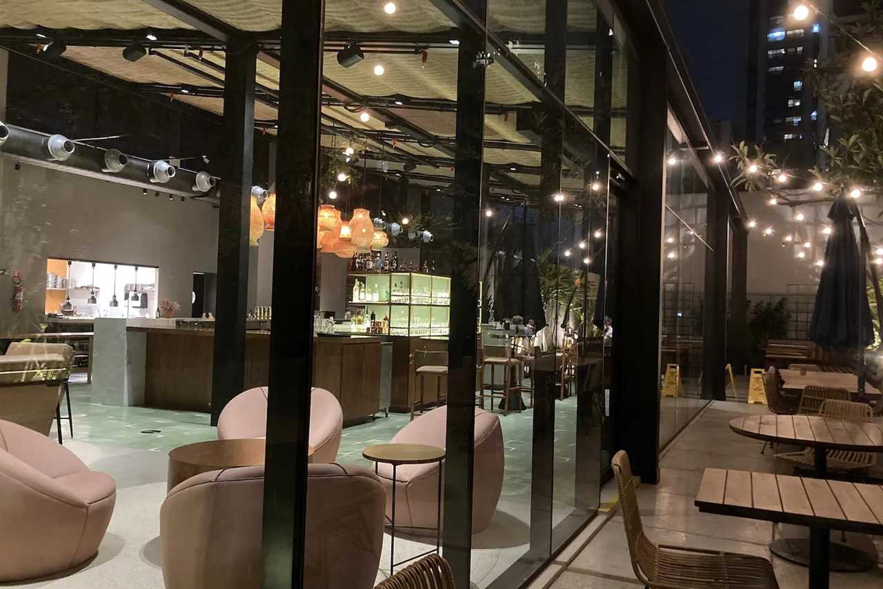 view from outdoor dining area through a window to the indoor dining area at a hotel