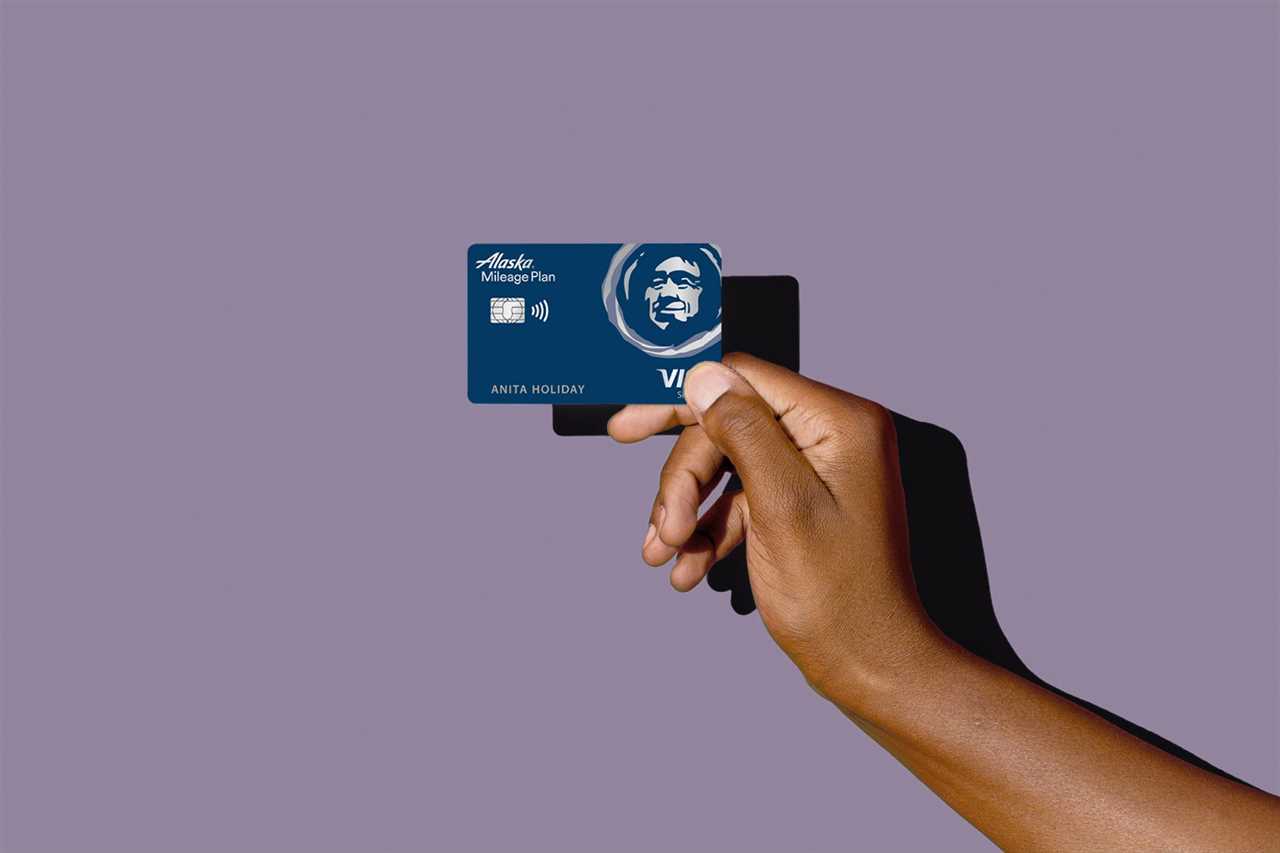 a hand holds a credit card