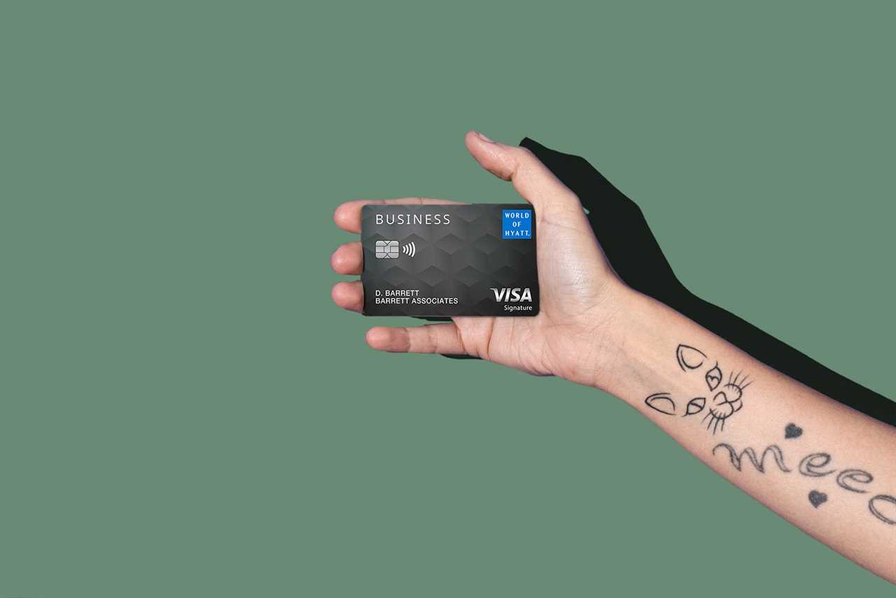 a hand holds a credit card