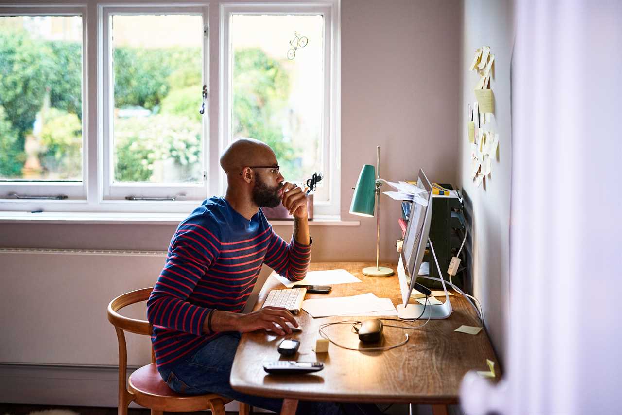 A man works remotely in a home office.