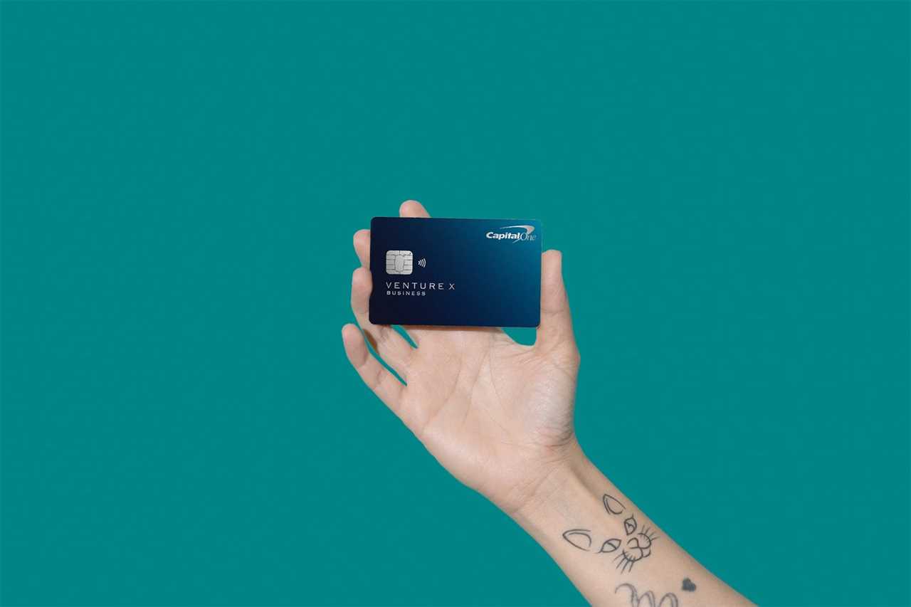 a hand holds a credit card