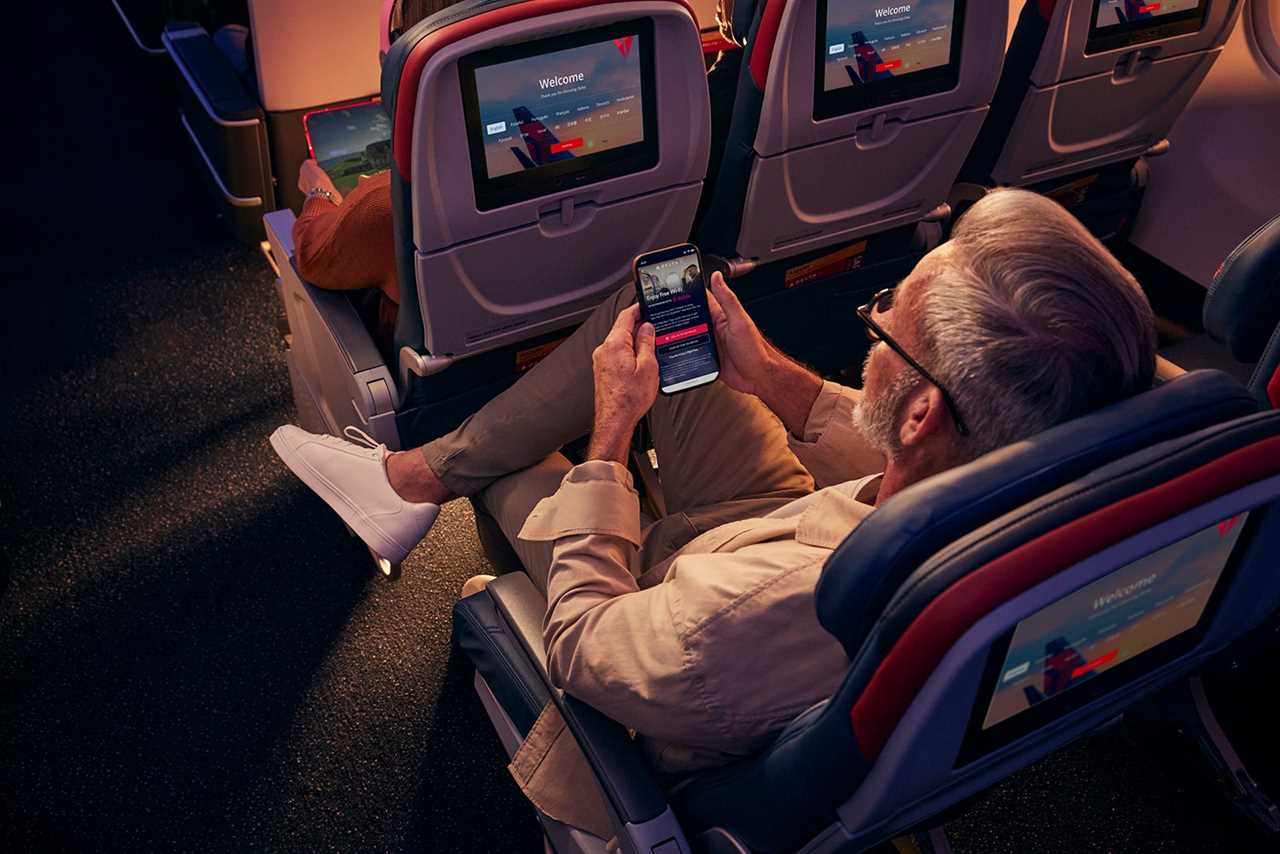 man on plane using his phone