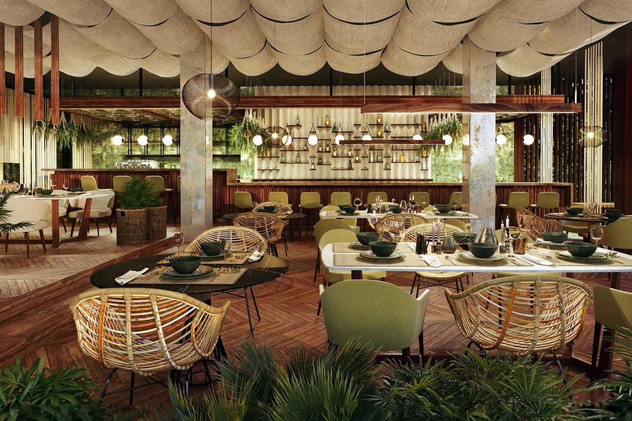 restaurant with tables at the forefront and bar with shelves of glass bottles in the back