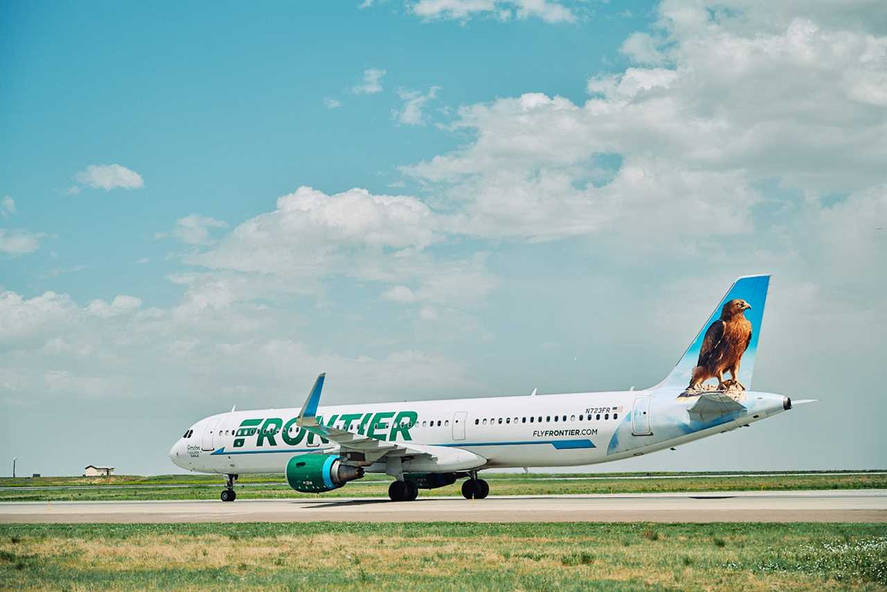 Frontier Airlines plane taxis at airport