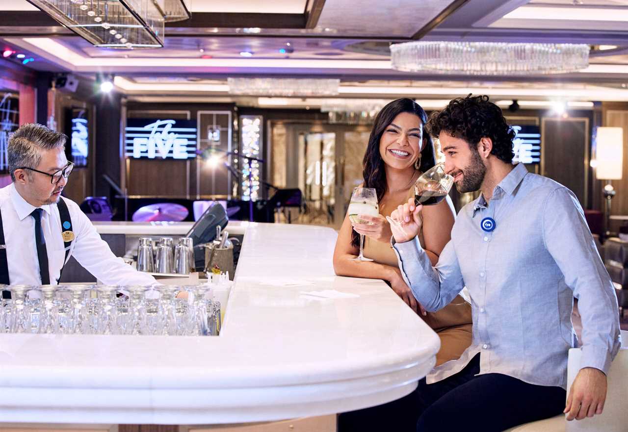 A couple drinks wine at a bar on a Princess Cruises ship