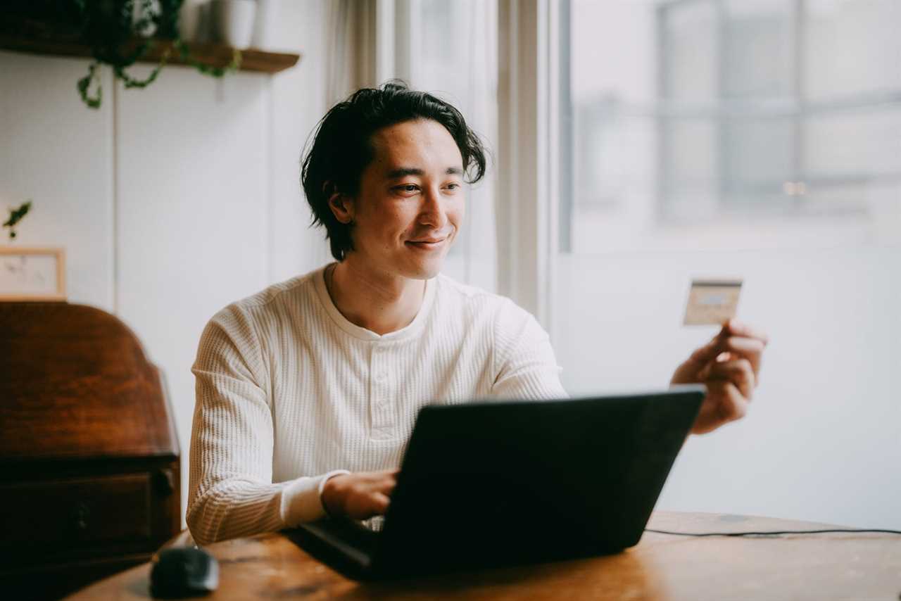 Man shopping online with credit card at home