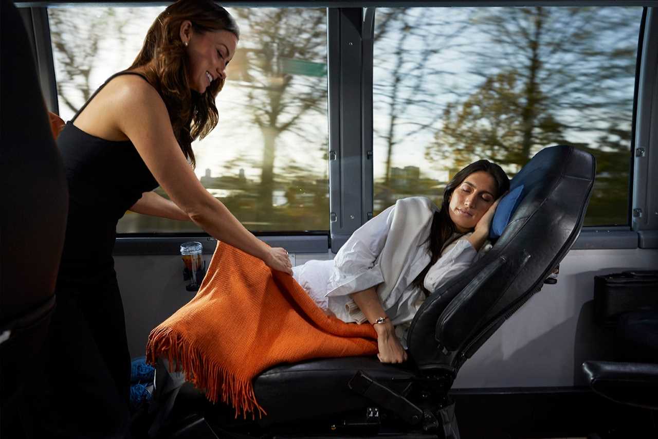 Interior of Blade Hamptons Streamliner-staff covering passenger with blanket