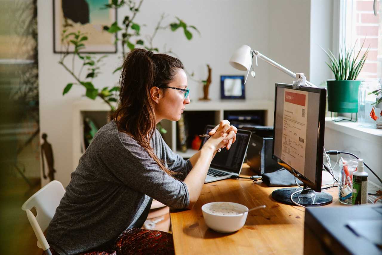 woman checking her online flight tickets at home